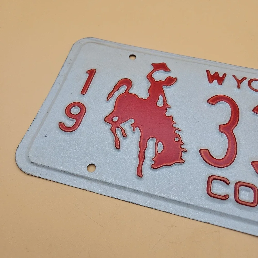 Vintage Wyoming License Plate Commercial Cowboy Bucking Horse Logo Red White